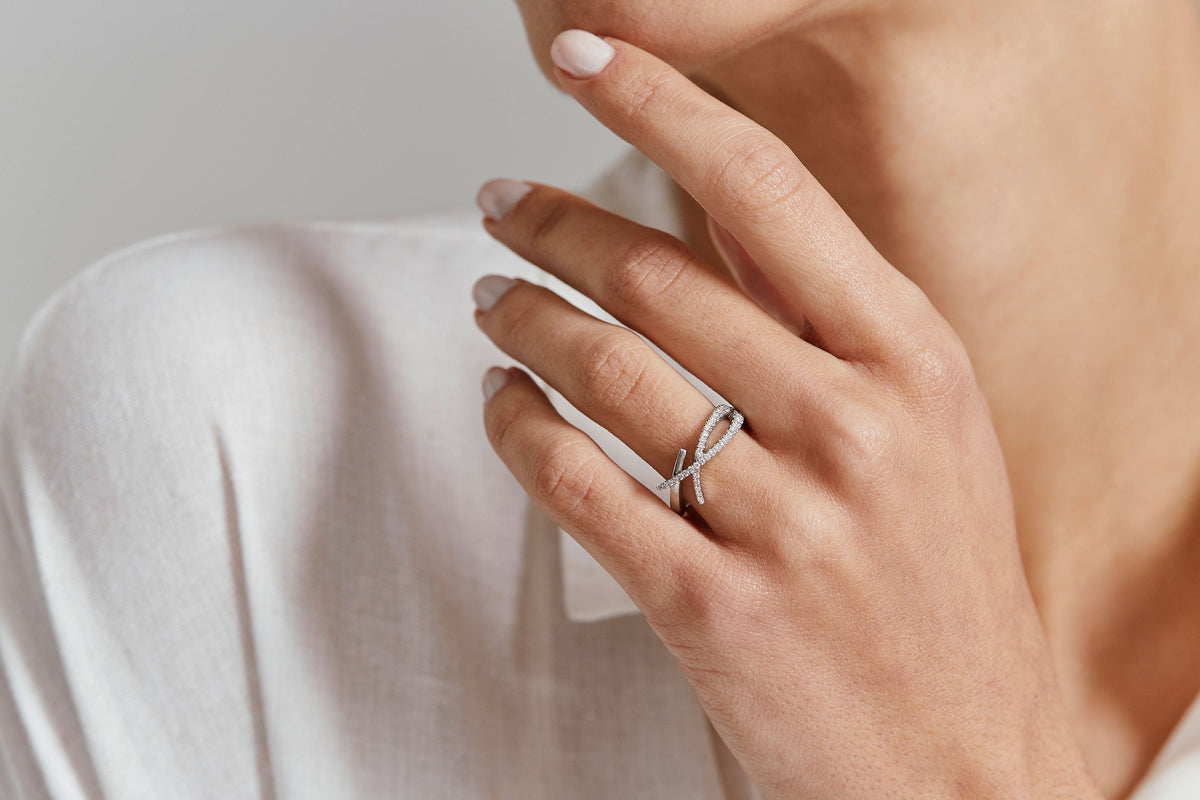 platinum and diamond crossover ring on the hand