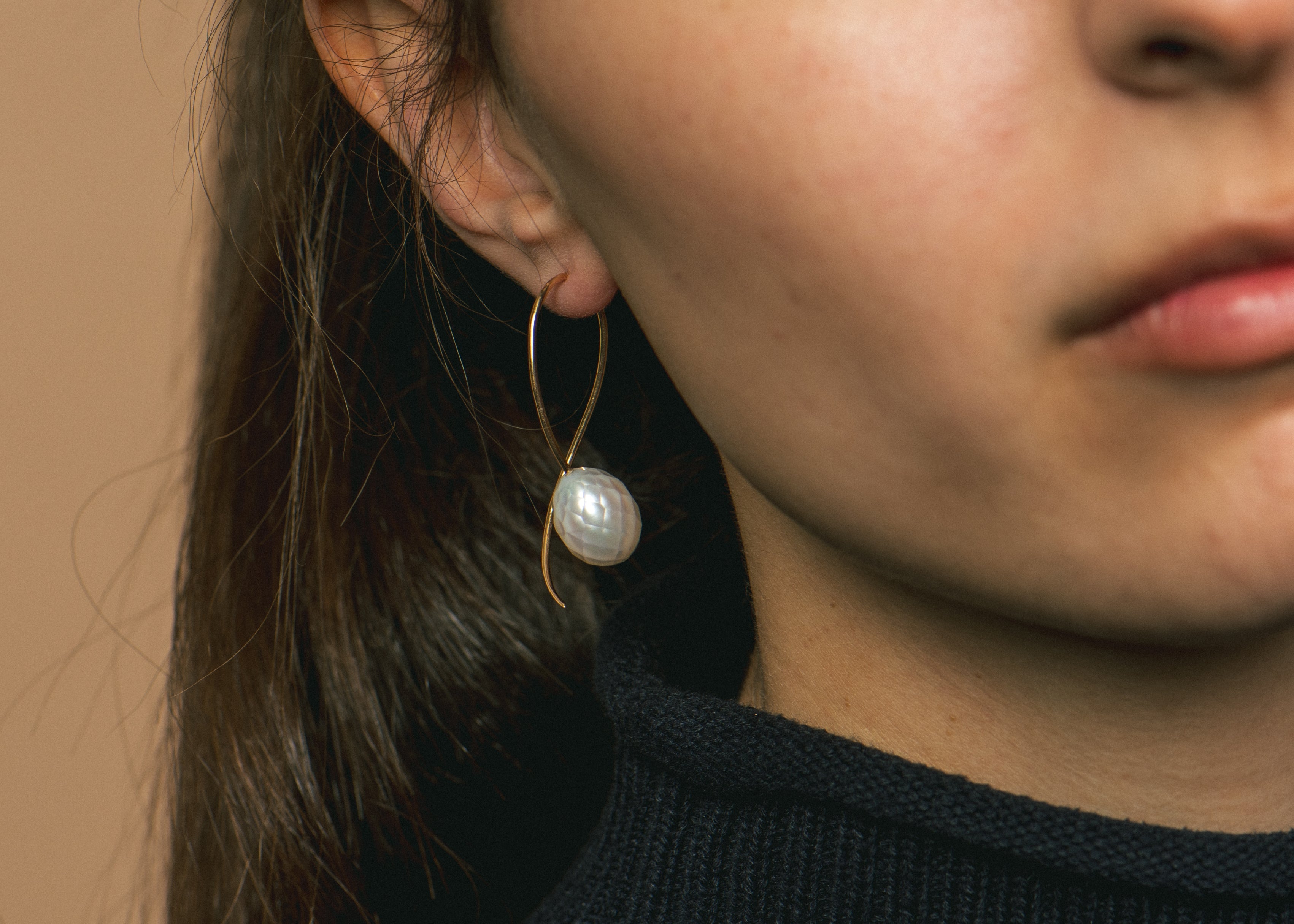 What are faceted pearls and how are they made?