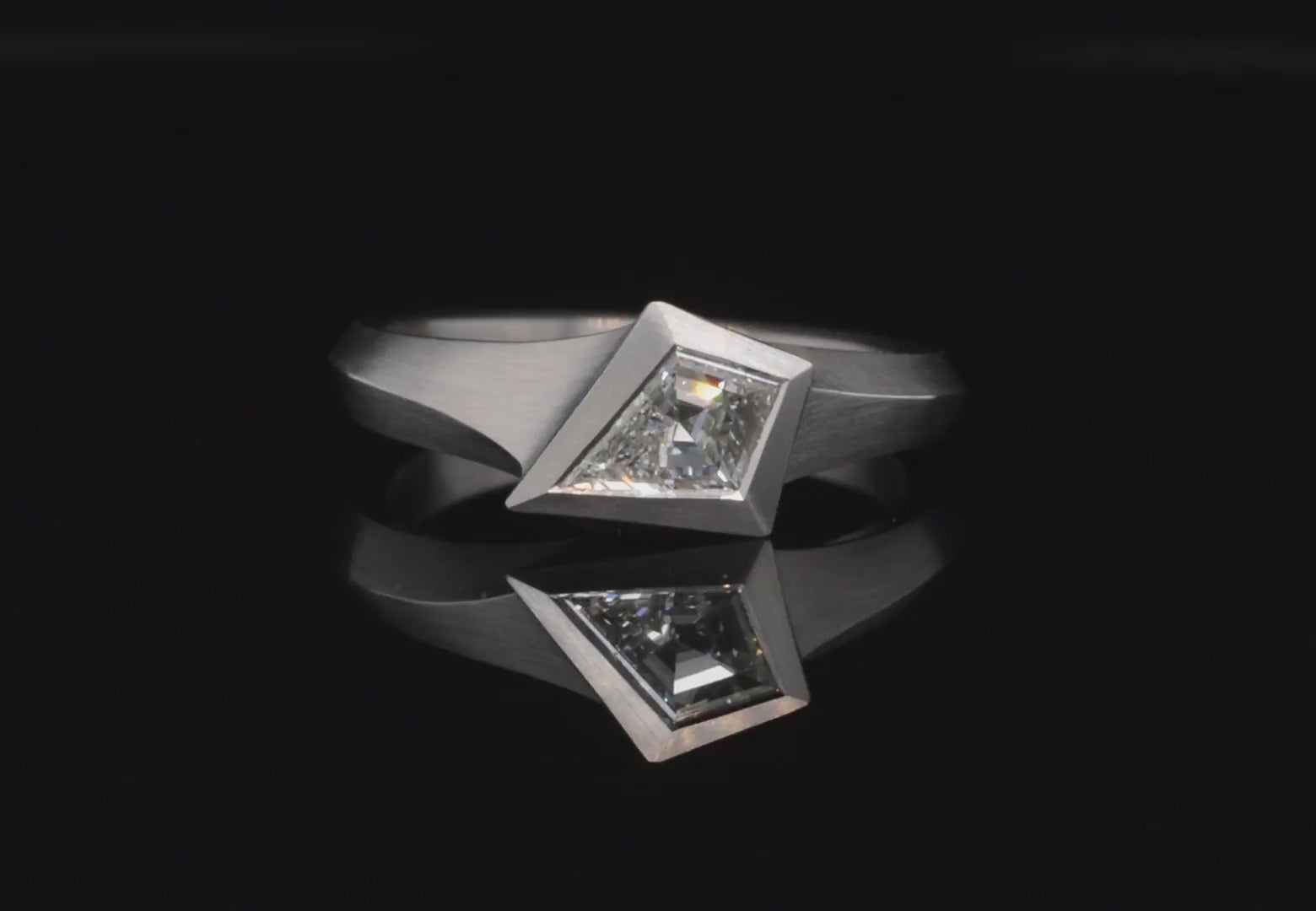Platinum Aegis ring with kite shaped white diamond.