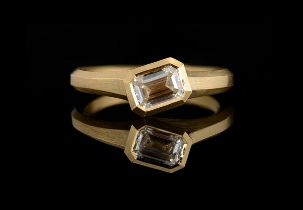Yellow gold Arris engagement ring with emerald-cut white diamond