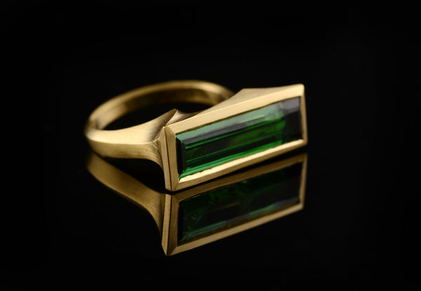 Carved yellow gold cocktail ring with baguette green tourmaline