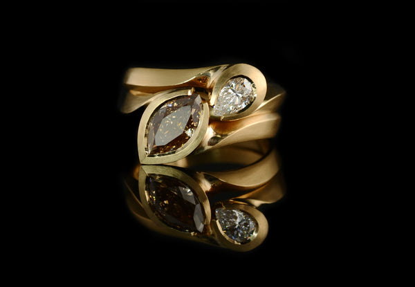 Carved rose gold ring set with pear and marquise diamonds