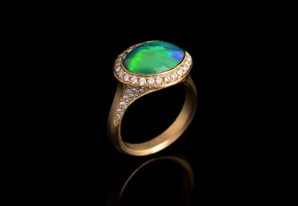Bespoke opal and yellow gold cocktail ring with white diamond halo