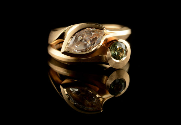Carved fitted engagement and wedding ring with marquise diamond and green sapphire