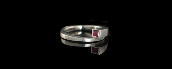 Forged platinum and ruby overlap engagement ring