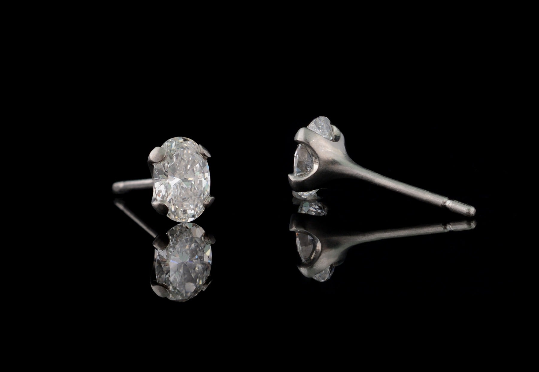 4 claw oval white diamond and platinum stud earrings