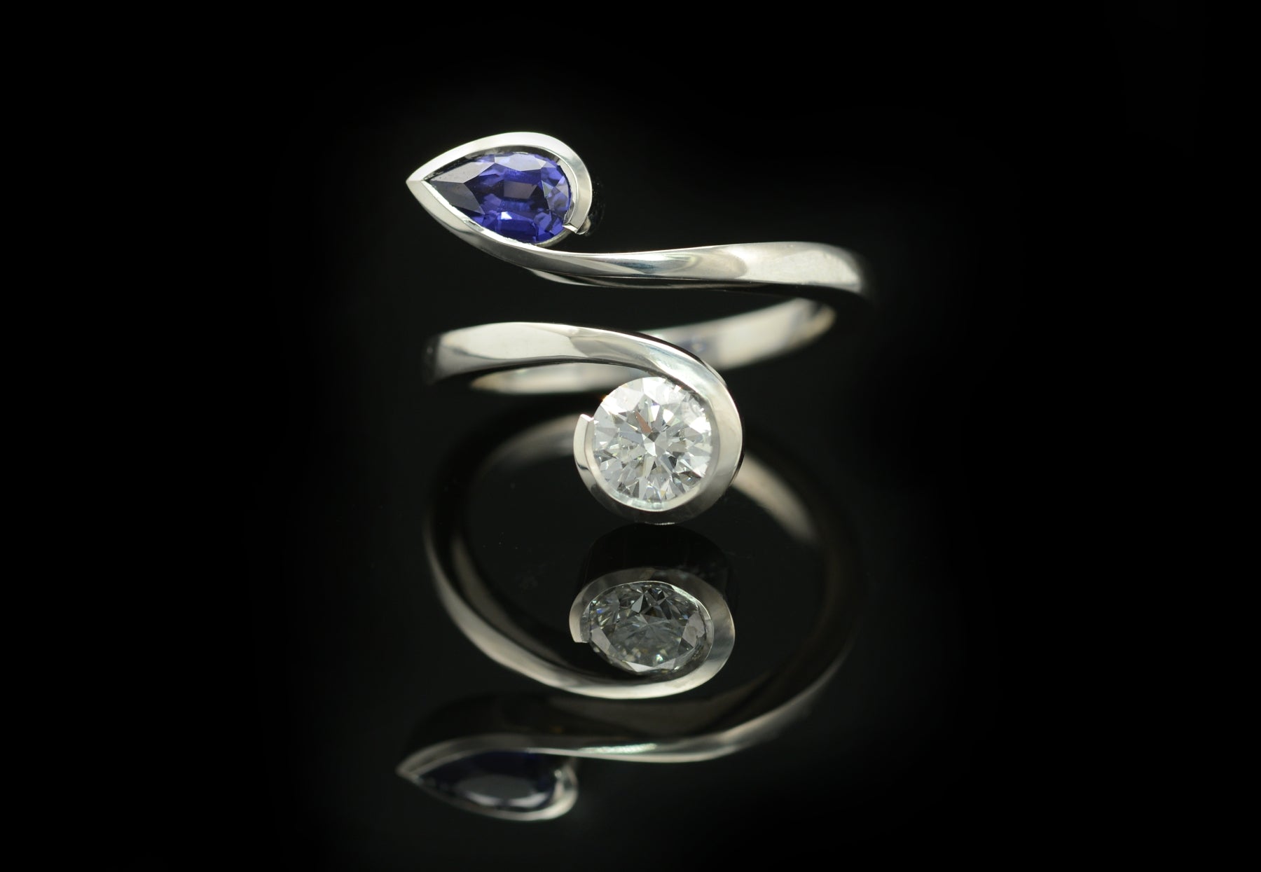 Twist two stone pear shape blue sapphire and round white diamond engagement ring