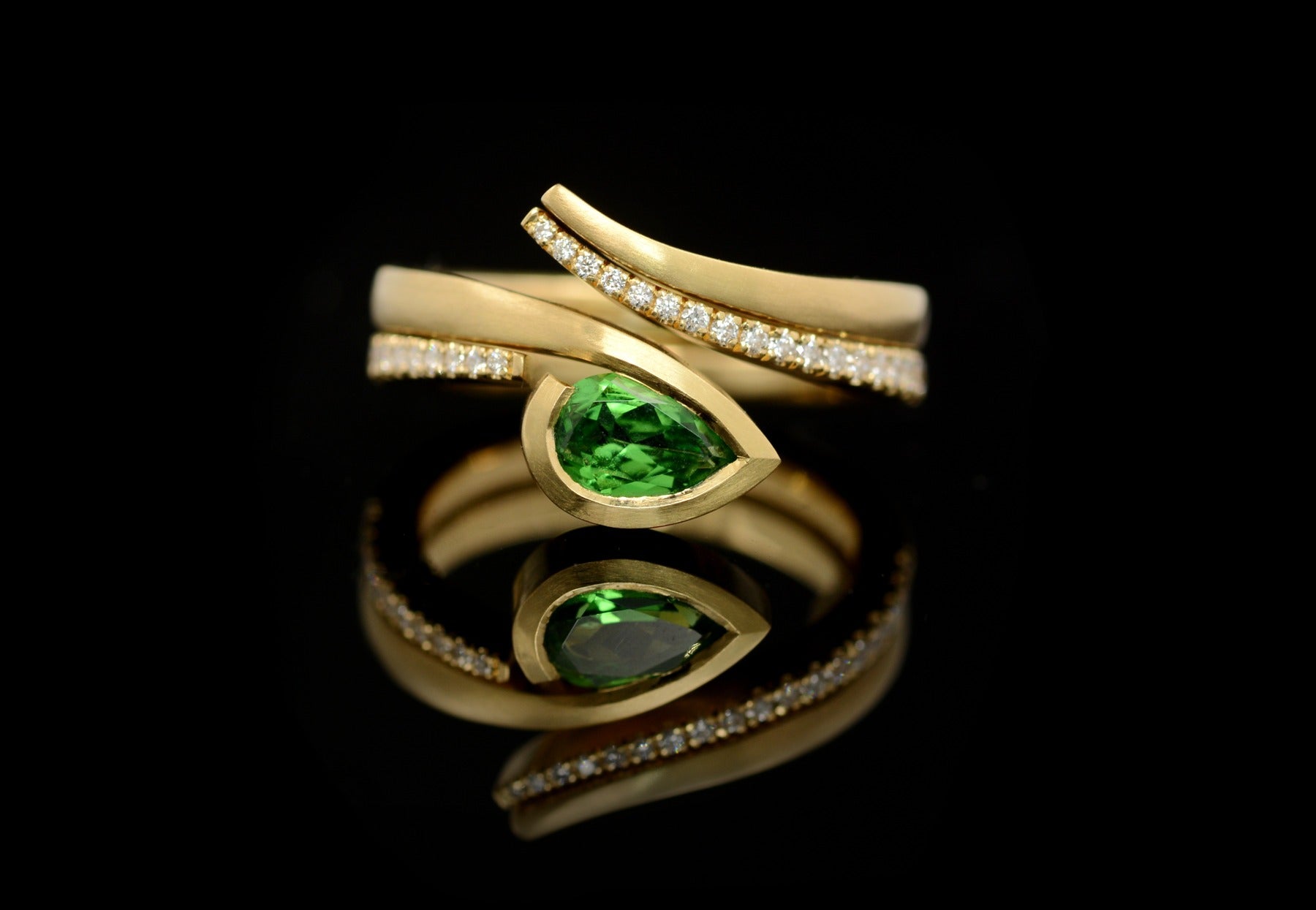 Twist tsavorite garnet and white diamond yellow gold engagement ring and fitted wedding ring