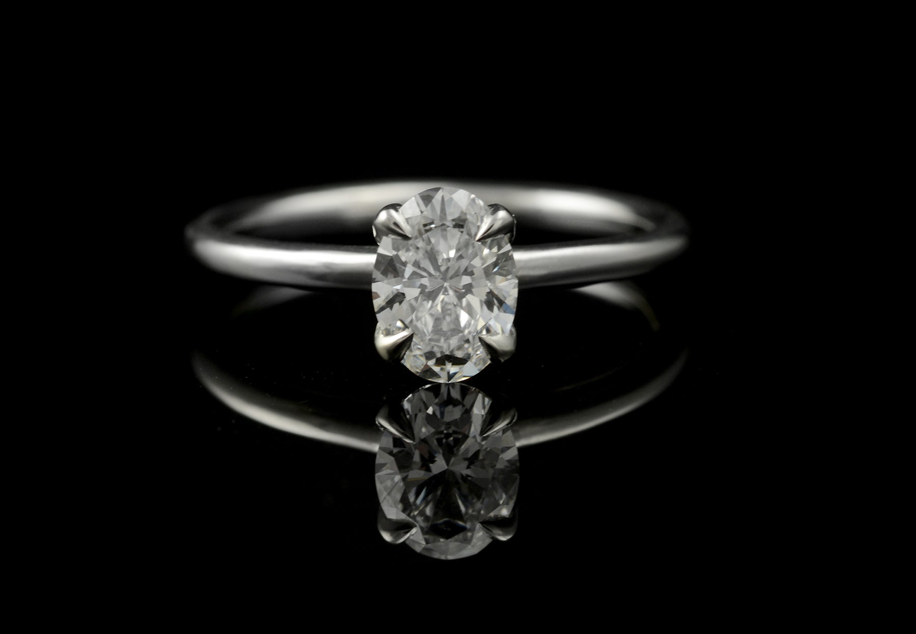 4 claw oval white diamond and platinum engagement ring