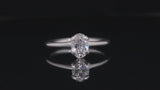 Oval diamond and platinum sculpted 4 claw engagement ring