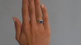 Platinum and oval blue sapphire wave engagement ring