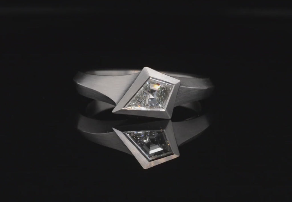 Platinum Aegis ring with kite shaped white diamond. 