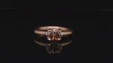 Rose gold four-claw engagement ring with oval cognac diamond