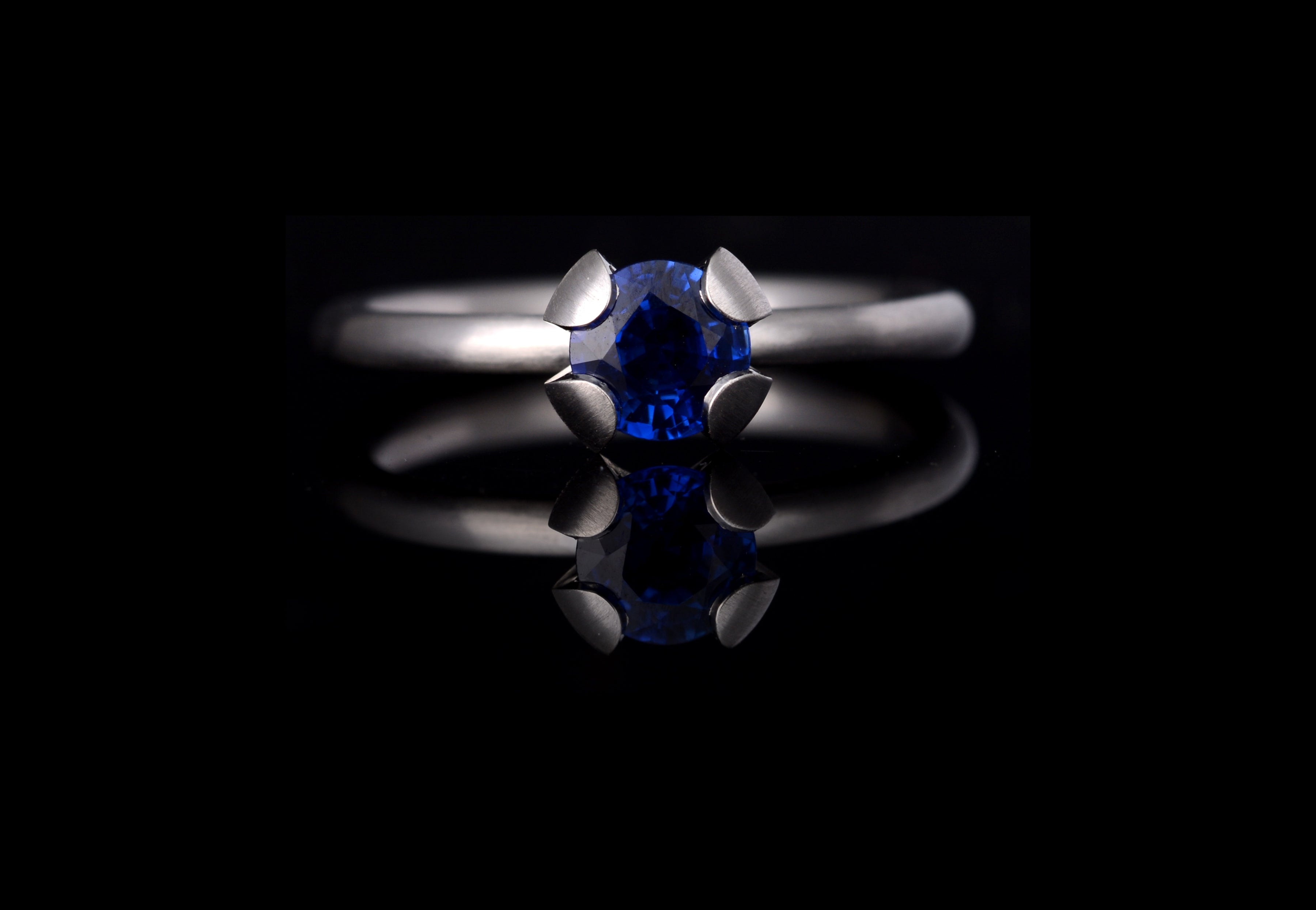 Platinum Calyx engagement ring with blue sapphire