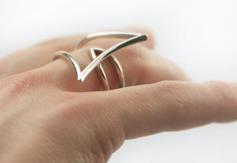 White forged wire cocktail ring on hand
