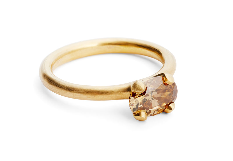 Modern rose gold engagement ring with oval cognac diamond