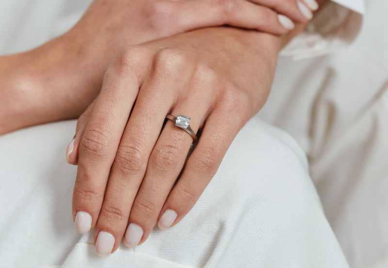 Arris contemporary platinum engagement ring with emerald-cut white diamond-McCaul