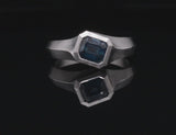 Platinum Arris ring with emerald cut sapphire